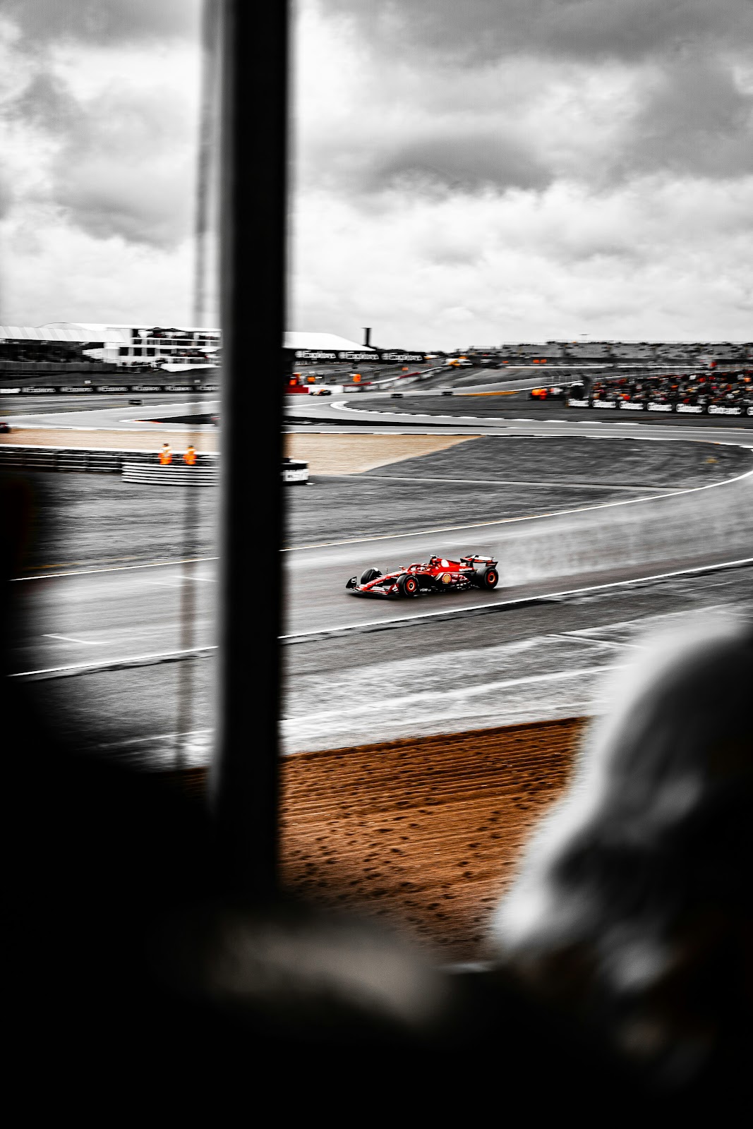 A black and white photo of a race car on a track